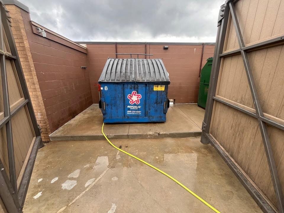 Cleaned commercial dumpster pad after service