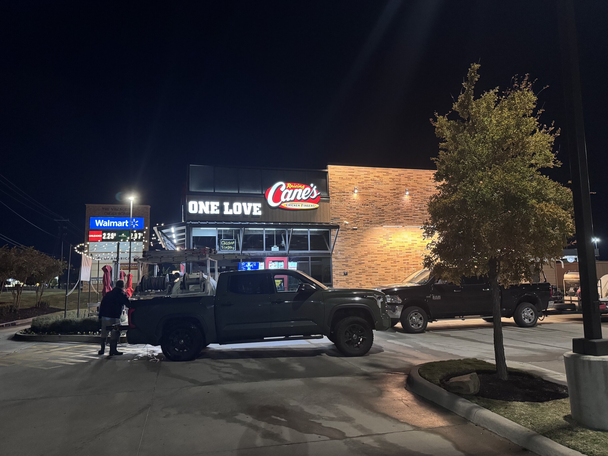 Primal Powerwashing truck and crew on a Raising Cane's lot after hours