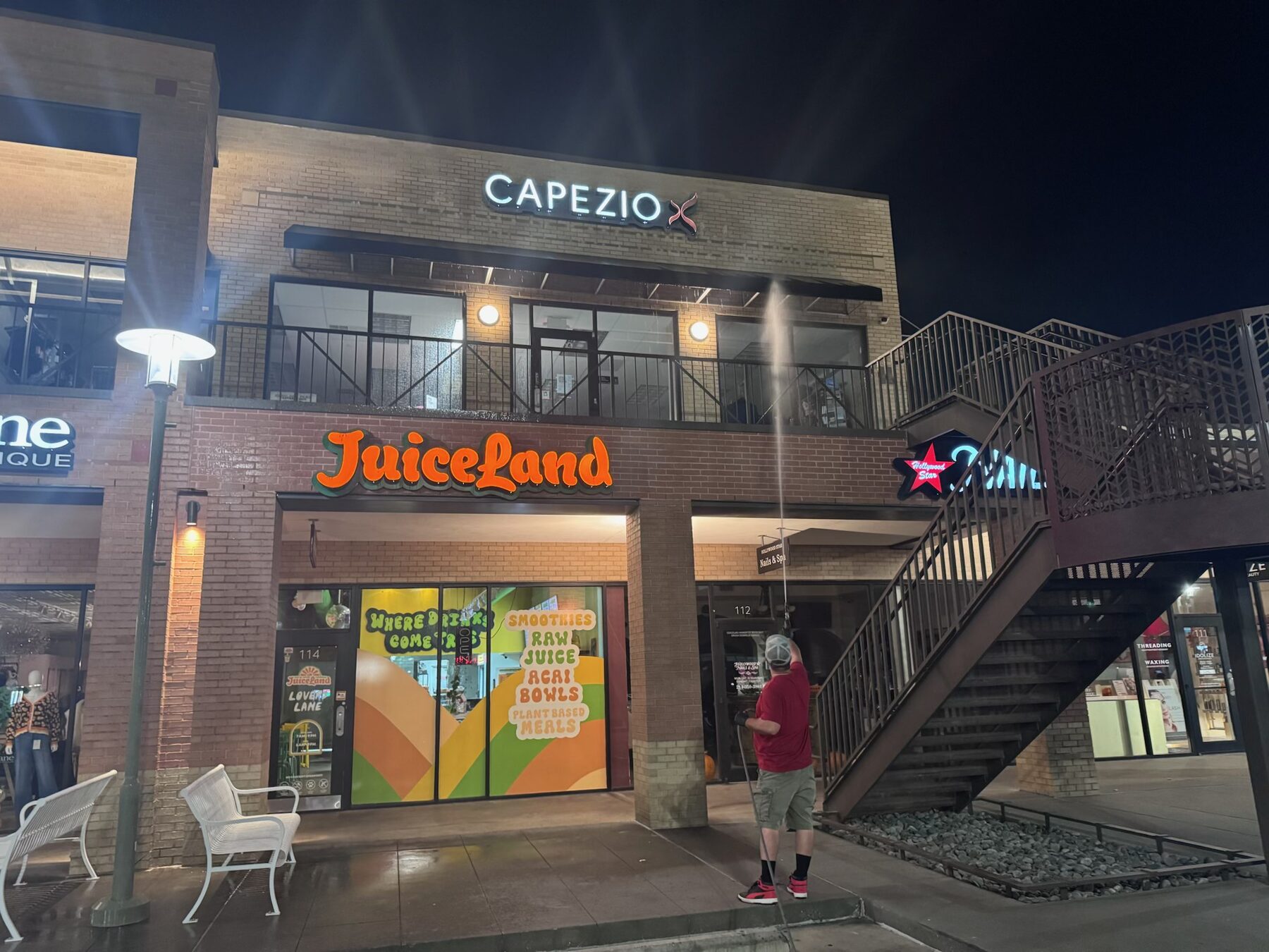 Commercial building exterior being washed after hours