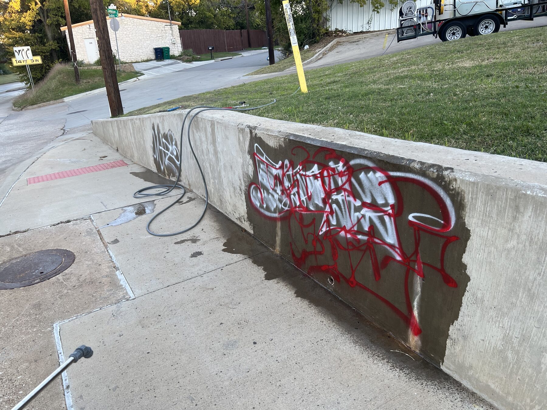 Graffiti on a concrete retaining wall during removal